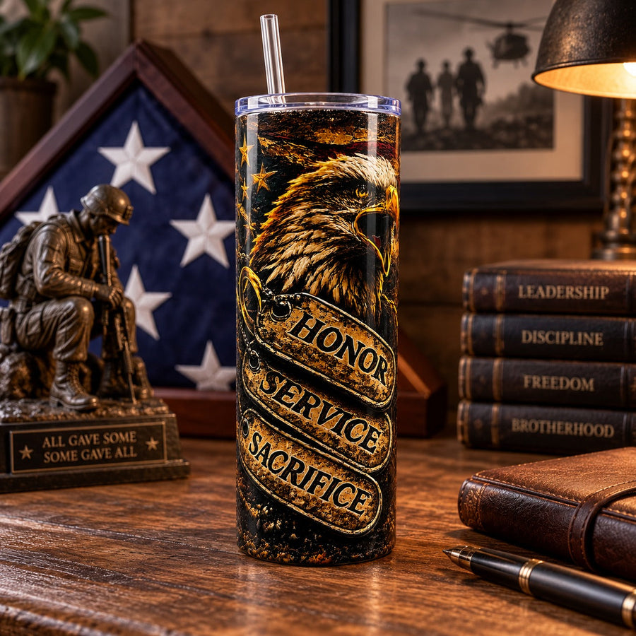Honor Service Sacrifice patriotic tumbler on a desk with folded flag